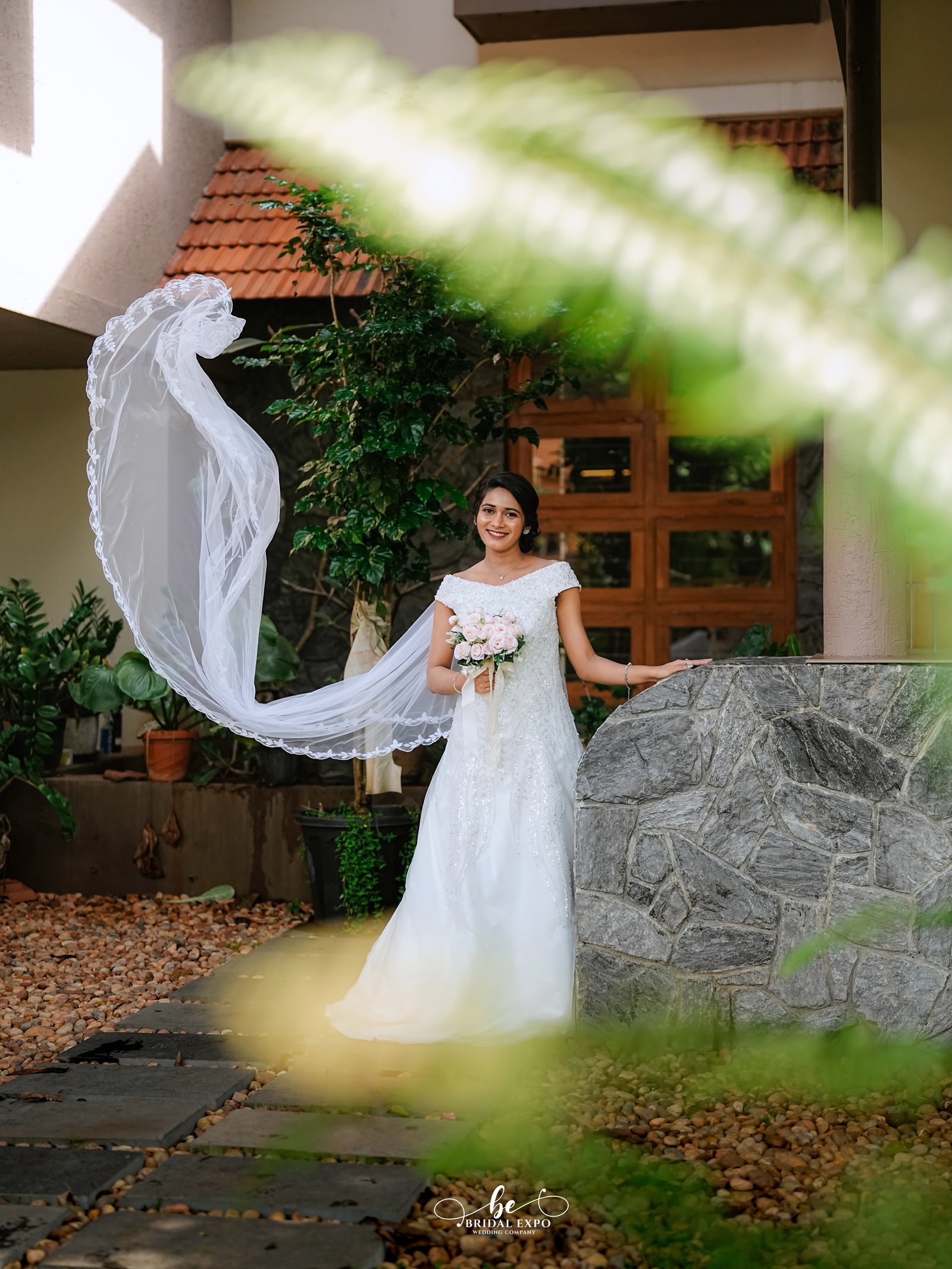 A couple sharing a serene moment along a garden pathway