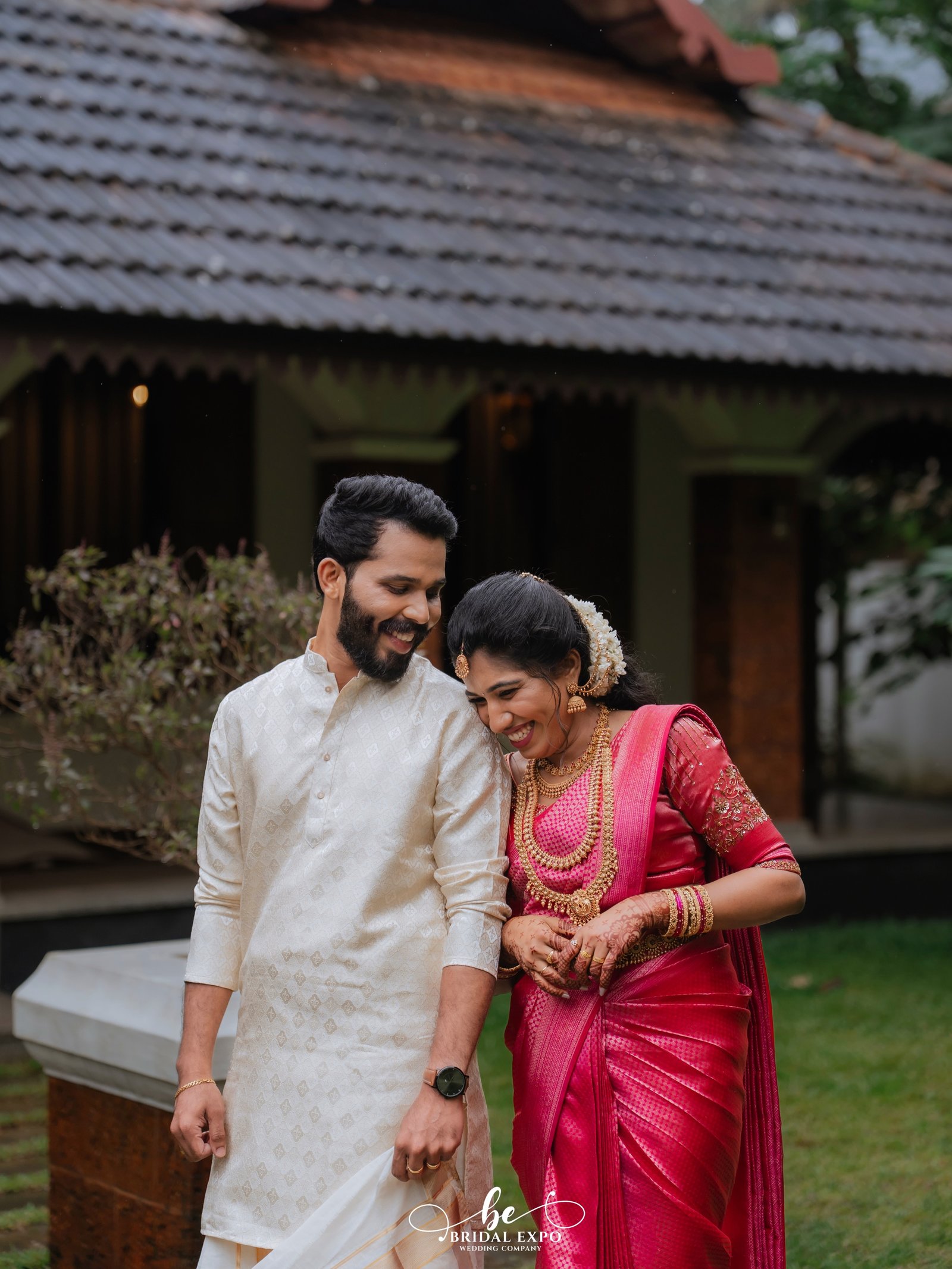 A newlywed couple standing together in scenic natural light